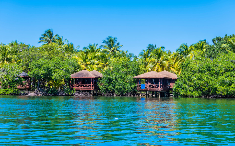 Ein Blick auf Strandh&uuml;tten in der N&auml;he von West Bay auf der Insel Roatan an einem sonnigen Tag